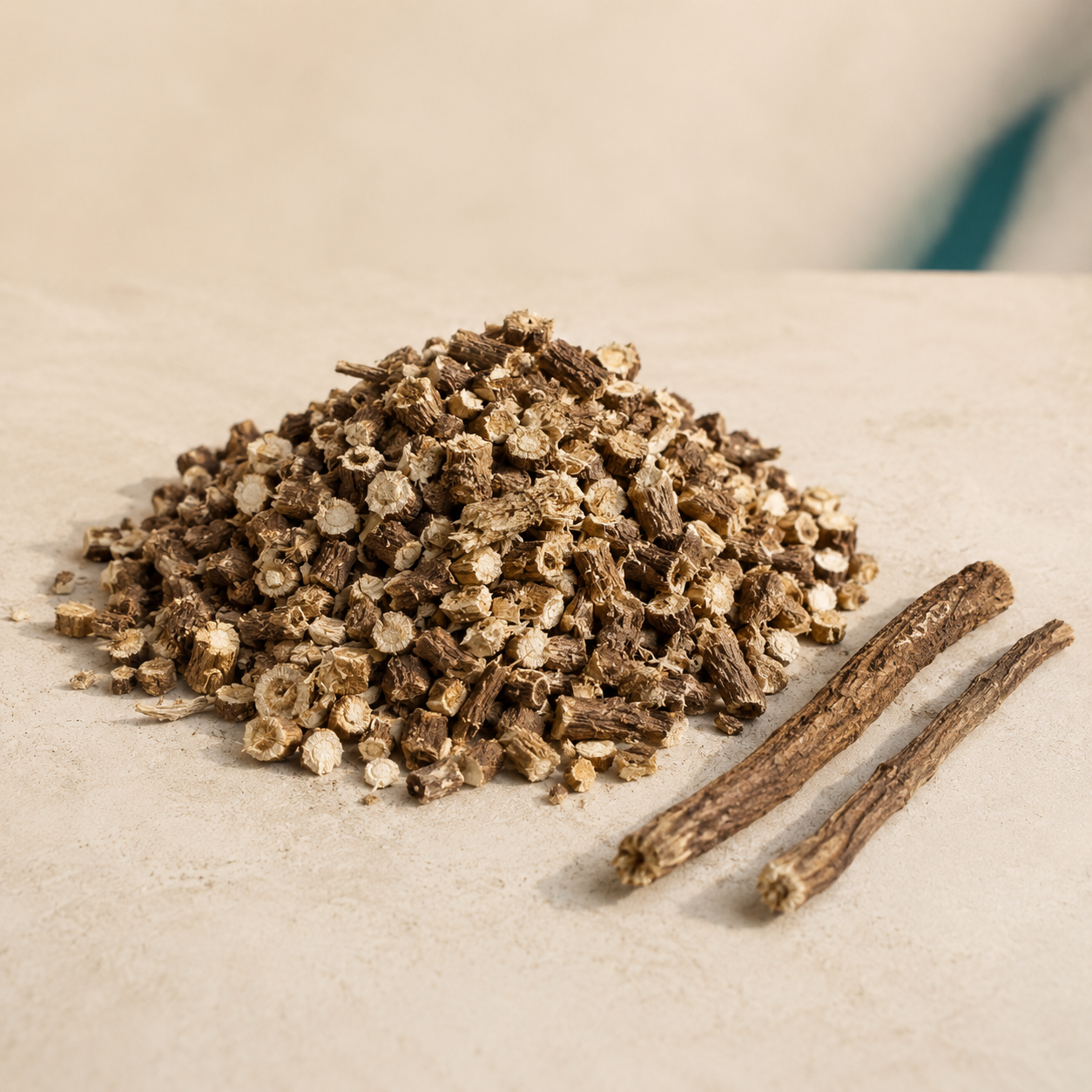 Dried cut dandelion root pieces on a warm cream background